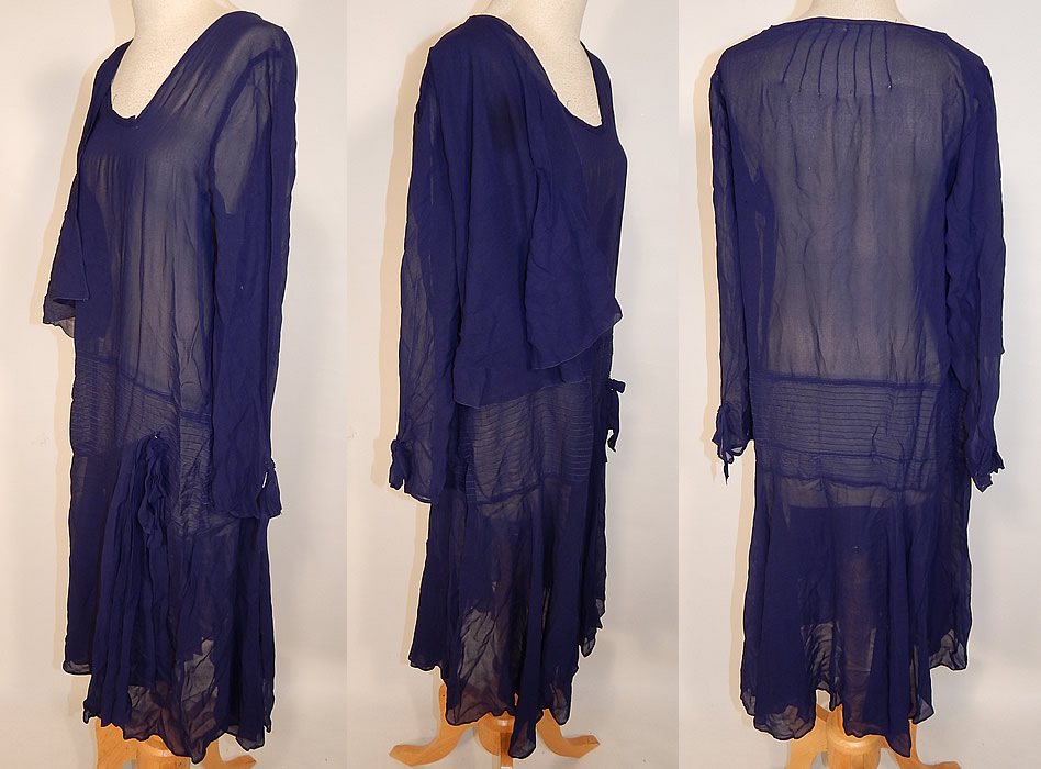 Vintage Art Deco Navy Blue Silk Chiffon Capelet Asymmetrical Drop Waist Dress
The dress measures 40 inches long, with a 36 inch waist, 36 inch bust and 21 inch long sleeve. It is in good as-is condition, with a few tiny holes on the back top, capelet, sleeve cuff and a stain on the shoulder capelet (see close-up). This is truly a wonderful piece of wearable art!