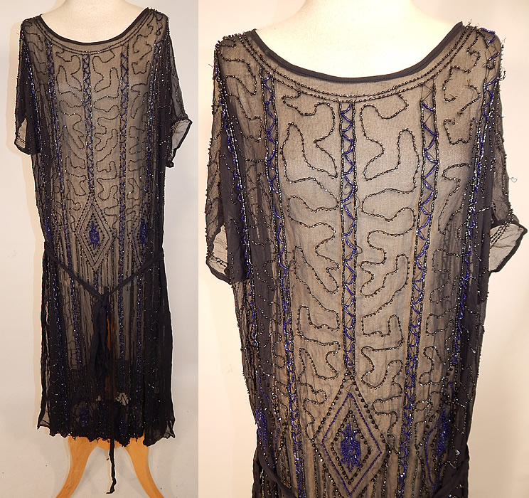 Vintage Art Deco Black Silk Chiffon Cobalt Blue Beaded Belted Drop Waist Flapper Dress
This amazing Art Deco vintage black silk chiffon cobalt blue beaded belted drop waist flapper dress dates from the 1920s. It is made of a sheer black silk chiffon fabric, with bright cobalt blue and black jet beading done in Art Deco abstract geometric diamond shapes, spiral, chevron designs.