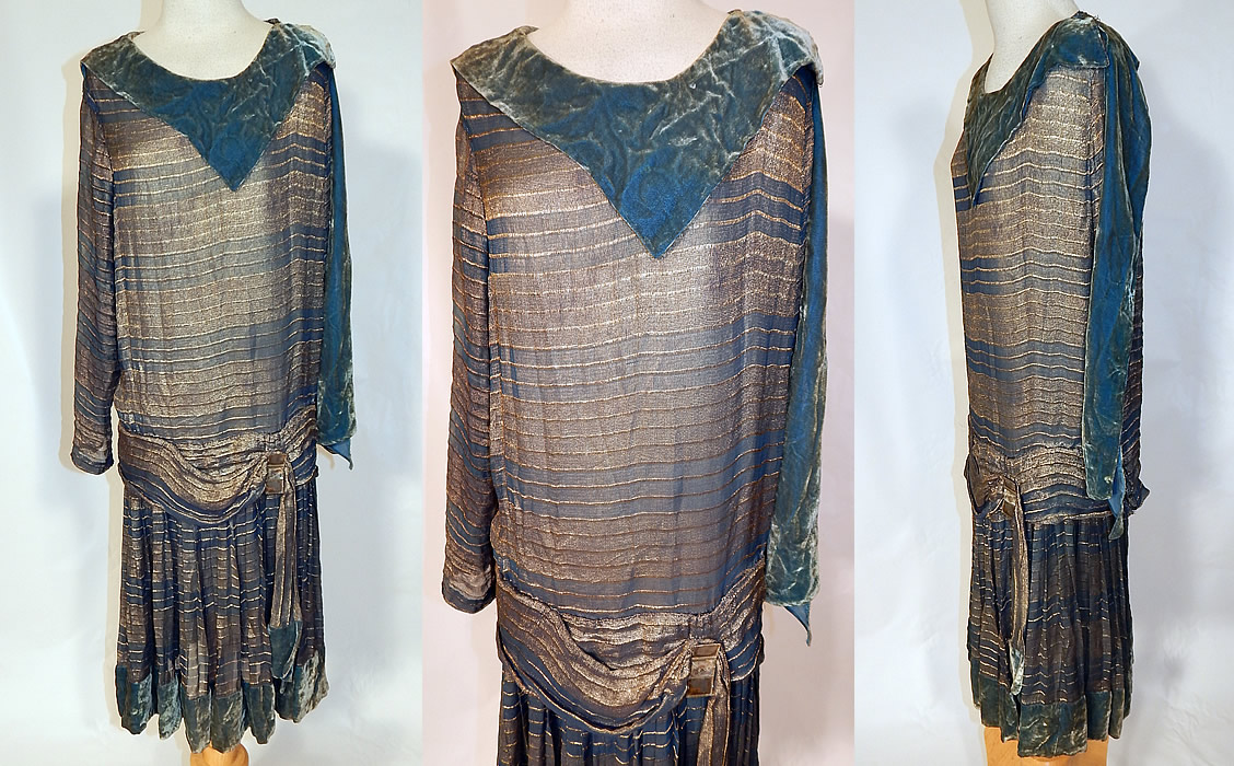 Vintage Art Deco Striped Blue & Gold Lam&eacute; Lame Velvet Drop Waist Flapper Dress
This fabulous flapper style drop waist dress is loose fitting, with an attached belted sash, buckle trim, a shawl style velvet collar with side neck scarf drape, long tapered sleeves, a pleated short skirt and is lined only in the top, the skirt silk lining was shattered and removed. 