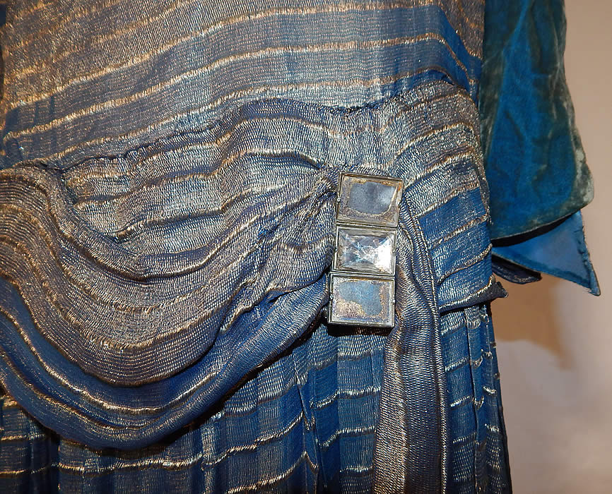 Vintage Art Deco Striped Blue & Gold Lam&eacute; Lame Velvet Drop Waist Flapper Dress
This vintage Art Deco striped blue and gold lam&eacute; velvet drop waist flapper dress dates from the 1920s. It is made of a blue and gold metallic silk lam&eacute; fabric, with a striped pattern design and blue silk velvet trim accents.