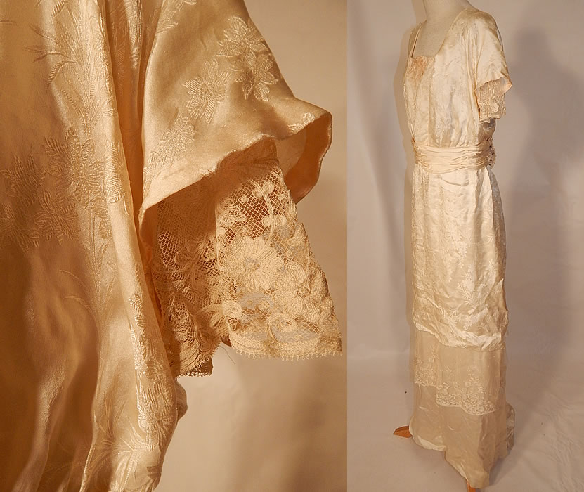 Edwardian Titanic Silk Damask Brocade Tambour Embroidery Lace Wedding Gown Dress
This beautiful bridal wedding dress has a long floor length layered tiered skirt with slight back train, squared necklines, layered short sleeves, a pleated belted sash waist, hook closures on the back and is fully lined.