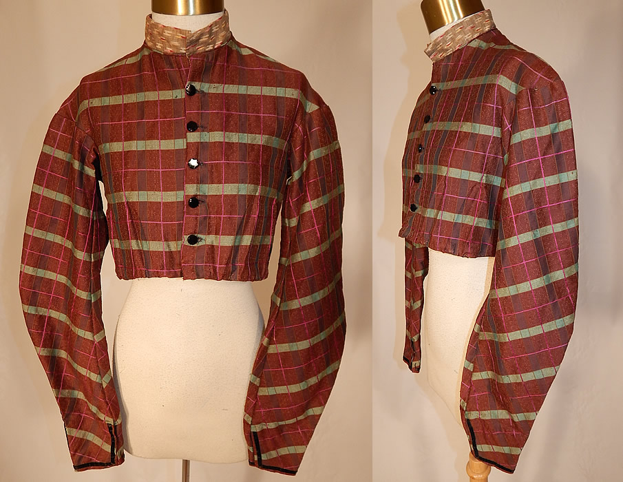 Victorian Civil War Brown Green Pink Plaid Stripe Wool Bodice Blouse Jacket Top
This antique Victorian Civil War era brown, green, pink plaid stripe wool bodice blouse jacket top dates from the 1860s. It is made of a brown fine woven wool fabric with a green and pink plaid striped pattern and black velvet ribbon trim edging the sleeves.