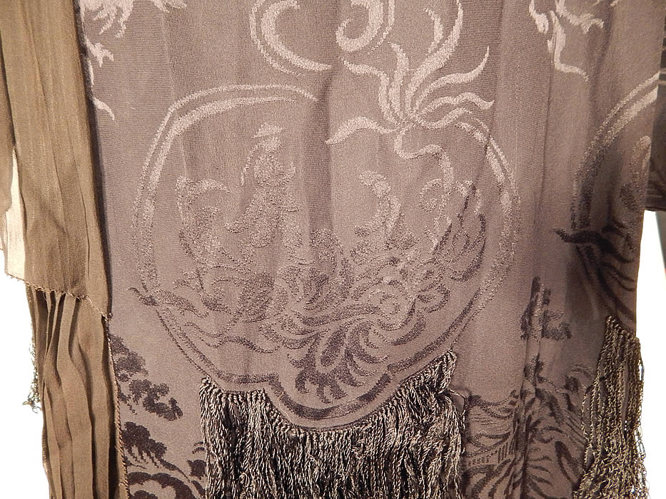 Vintage Black Silk Damask Oriental Chinese Figural Fringed Flapper Dress
The dress measures 45 inches long, with 44 inch hips, a 42 inch waist, 40 inch bust and 22 inch long sleeves. It is in excellent condition. This is truly a wonderful piece of Asian inspired wearable textile art!