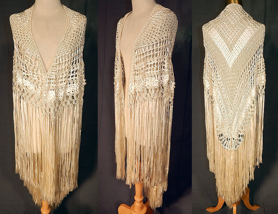 Vintage White Boho Macrame Crochet Silk Ribbon Fringe Flapper Wedding Shawl
This vintage white boho macram&eacute; crochet silk ribbon fringe flapper wedding shawl dates from the 1920s. It is made of a white silk ribbon work fabric, with macram&eacute; crochet woven decorative designs. This fabulous flapper wedding shawl scarf wrap has a triangle shape, with hand knotted white silk fringe along the sides and bottom only. 