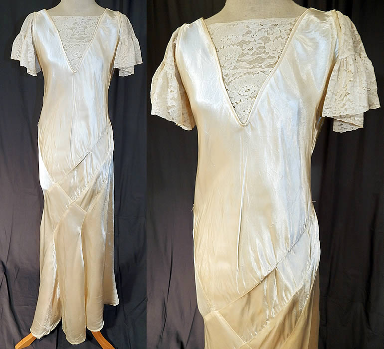 Vintage White Silk Satin & Lace Asymmetrical Bias Cut Wedding Gown Dress
This vintage white silk satin and lace asymmetrical bias cut wedding gown dress dates from the 1930s. It is made of a white silk satin fabric, with white lace trim front top insert and sleeves.