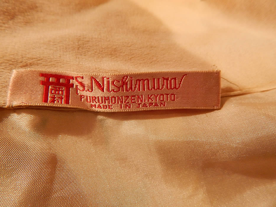 Vintage S. Nishimura Kyoto Japan Pink Silk Screen Cherry Blossom Japanese  Kimono
It has long swinging sleeves, an open front with no closure and is fully lined, with an "S. Nishimura Furumonzen, Kyoto Made in Japan" label sewn inside. 