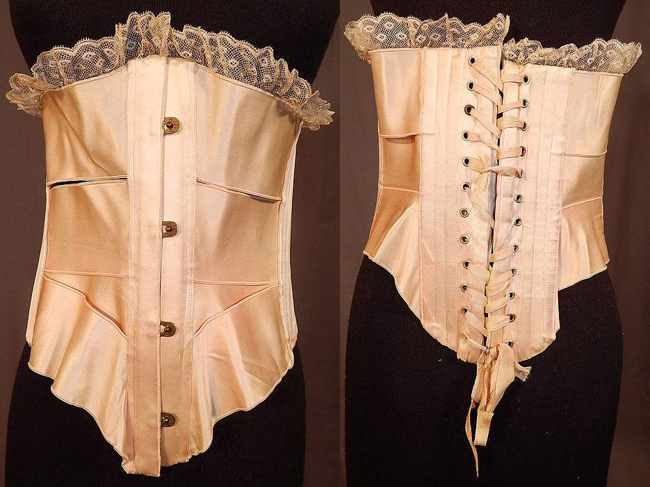 Victorian Antique Lace Trim Pink Silk Ribbon Short Negligee Night Corset Waist Cincher
This antique Victorian era lace trim pink silk ribbon short negligee night corset waist cincher dates from 1900. It is made of a pale pink pastel silk satin ribbon pieced and woven together, with white lace scalloped ruffle trim edging around the top. 