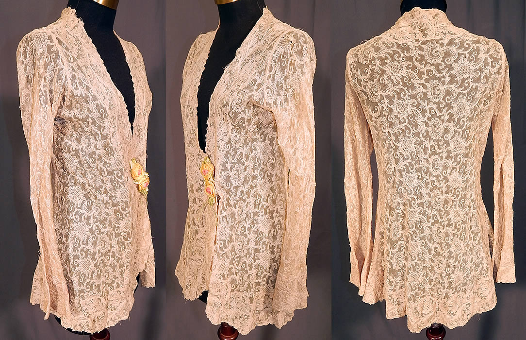 Vintage Silk Ribbon Rosette Trim Cream Tambour Embroidery Net Lace Jacket
This lovely lace boudoir jacket is a long mid length, with a form fitting wrap style, long tapered sleeves, a scalloped low V neckline, snap closure under the rosette trim and is sheer, unlined.