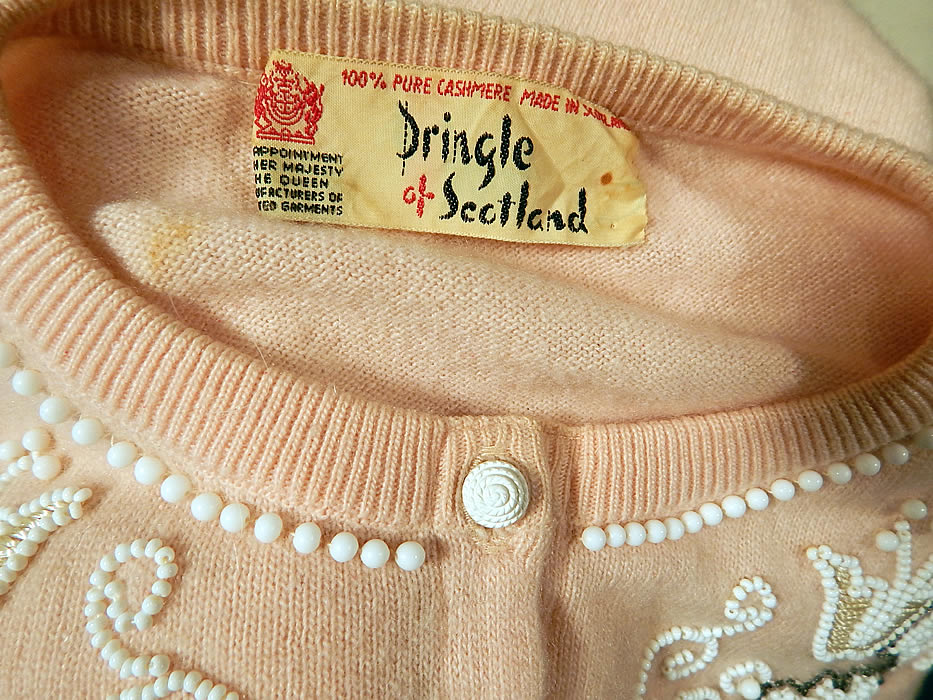 Vintage Pringle of Scotland Pink Cashmere White Beaded Cardigan Sweater
The sweater measures 20 inches long, with a 24 inch waist, 38 inch bust and 19 inch long sleeves. There is a "Pringle of Scotland Made in Scotland" label sewn inside.