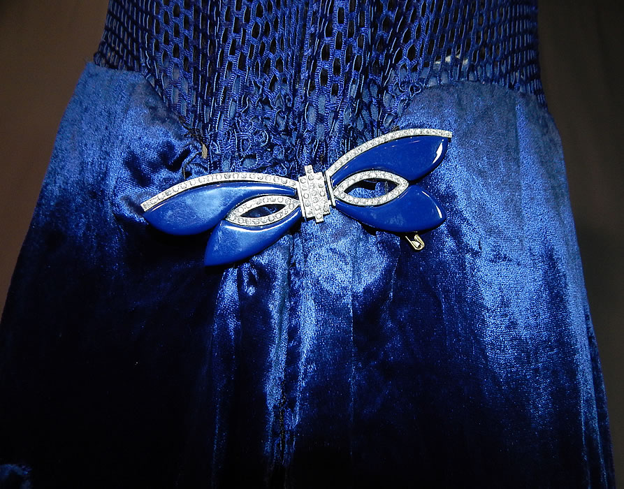 Vintage Art Deco Blue Silk Velvet Mesh Top Rhinestone Butterfly Buckle Flapper Dress
This fabulous flapper dress has a sheer see through mesh sleeveless tank top, with V front neckline, slight drop waist, blue enamel rhinestone butterfly buckle clasp trim pinned onto the front waist, a full skirt which is lined and unlined top. 