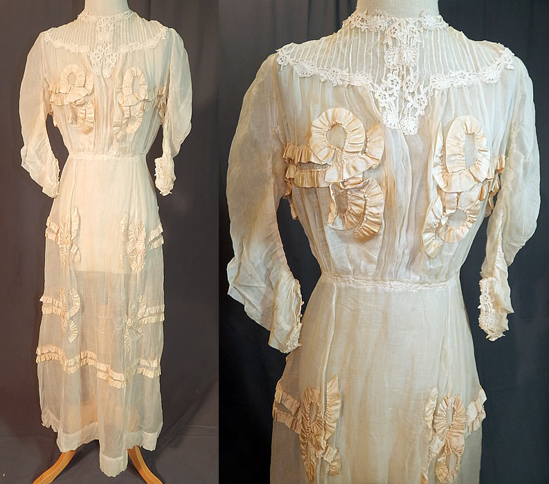 Edwardian White Cotton Muslin Lace Silk Ribbon Ruched Ruffle Trim Wedding Dress
This antique Edwardian era white cotton muslin lace silk ribbon ruched ruffle trim wedding dress dates from 1910. It is made of a sheer fine off white cotton muslin fabric, with lace trim around the neckline, yoke, cuffs and cream silk ribbon ruched ruffle bow trim accents appliqu&eacute;d