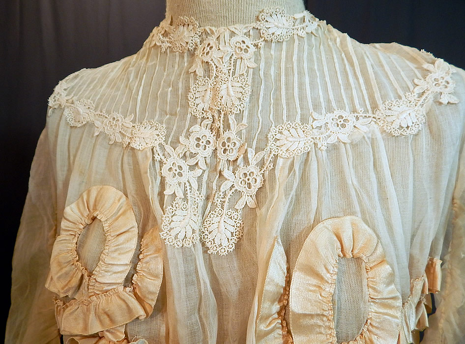 Edwardian White Cotton Muslin Lace Silk Ribbon Ruched Ruffle Trim Wedding Dress
This lovely lace long floor length dress has gathered shoulders with 3/4 length full tapered sleeves, a pouter pigeon front bodice, fitted waist, hook closures down the back and is sheer, totally unlined. 