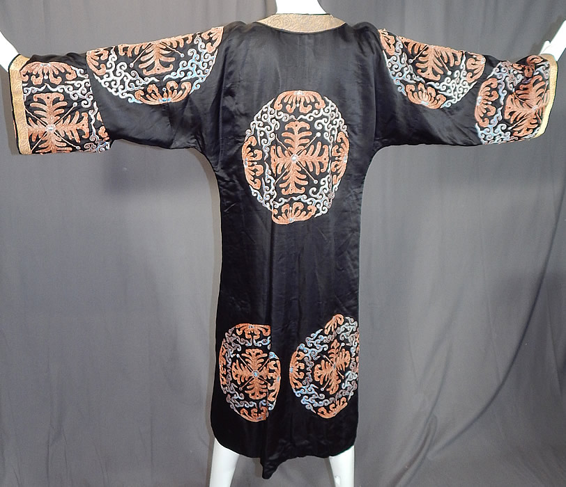 Antique Chinese Black Silk Embroidered Shou Longevity Medallion Gold Couching Coat Robe
This magnificent Manchu robe surcoat is a long length, loose fitting, with a front opening knotted button toggle closures, long sleeves, with woven silk trim edging the cuffs, collar and is fully lined. 
