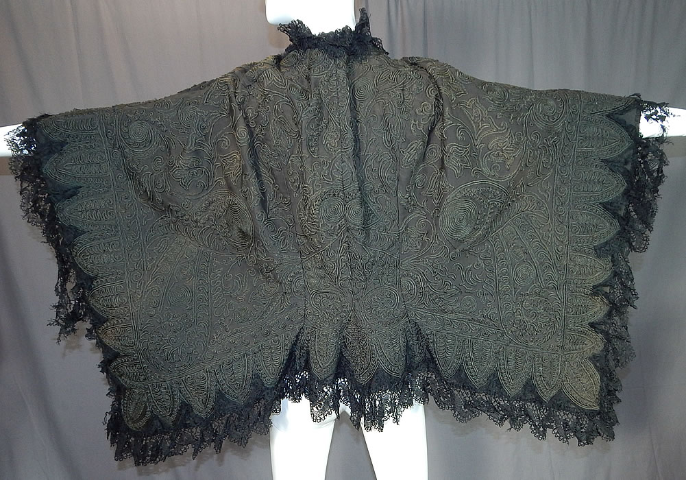 Victorian Black Wool Soutache Embroidery Work Lace Dolman Mantle Cape
This magnificent winter dolman mantle style cloak cape has a scalloped trim bottom edging, black lace trim ruffle neck collar, hook closure at the neck and is fully lined. 