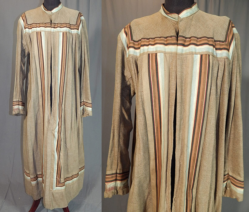 Victorian Taupe Tweed Wool Striped Ribbon Trim Wrapper Morning Dress Robe
This antique Victorian era taupe tweed wool striped ribbon trim wrapper morning dress robe dates from the 1860s. It is made of a grayish beige brown taupe color tweed woolen woven twill textured fabric, with shades of brown, blue and cream striped ribbon trim edging.