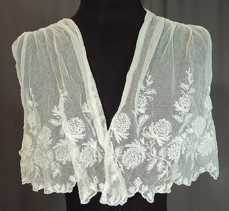 Edwardian White Tambour Embroidery Lace Net Bolero Jacket Sleeveless Vest Crop Top
This antique Edwardian era white tambour embroidery lace net bolero jacket sleeveless vest crop top dates from 1910. It is made of a white sheer tulle net fabric with tambour embroidery work done in a decorative stitched floral vine leaf design.