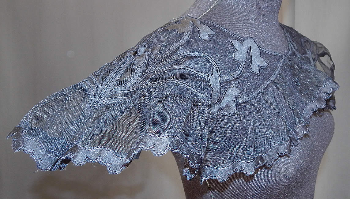 Vintage Black Silk Tulle Net Applique Shawl Collar Cape Capelet Dress Trim
This large shawl collar cape capelet dress trim has a ruffled bottom flounce, over the head style with no closure and is sheer, unlined. 