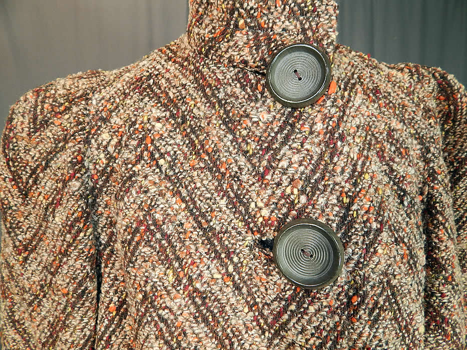 Vintage Lady Lee Evelyn Shop Chevron Stripe Tweed Knit Boucle Wool Winter Coat
This wonderful women's winter coat has a long below the knee length style, with a band collar, gathered shoulders, long full sleeves, side slit pockets, 4 large taupe gray plastic buttons for closure on the front and is fully lined in a brown satin fabric inside. 