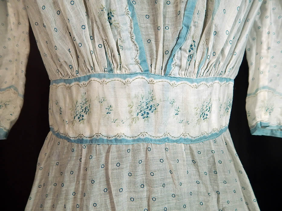 Victorian Blue & White Cotton Batiste Polka Dot Floral Calico Print Girls Dress
This girls pretty party dress has a short mid length skirt, with 3/4 length sleeves, a fitted floral print waistband, Swiss dot white net lace trim neckline, pleated accents, button closures down the back and is unlined.