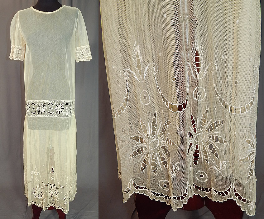 Vintage Cream Sheer Tulle Net Eyelet Cutwork Lace Floral Drop Waist Dress
This vintage cream sheer tulle net eyelet cutwork lace floral drop waist dress dates from the 1920s. It is made of an off white cream color sheer tulle net lace fabric with eyelet cutwork done in a floral garland design along the bottom skirt scalloped hem, front waistband and sleeve cuffs.