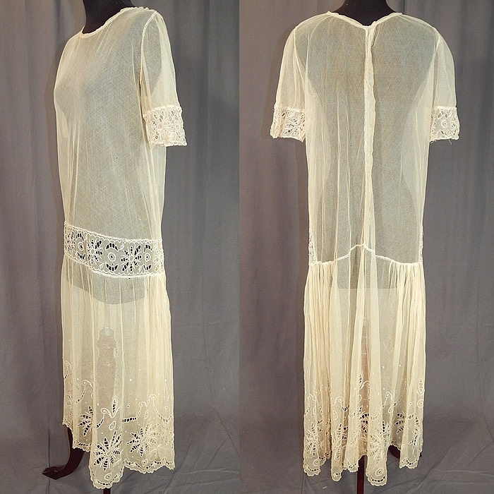 Vintage Cream Sheer Tulle Net Eyelet Cutwork Lace Floral Drop Waist Dress
The dress measures 48 inches long, with 42 inch hips, a 36 inch waist and 38 inch bust. It is in good condition, with slight underarm stains and a few tiny pin holes. This is truly a wonderful piece of wearable lace art! 