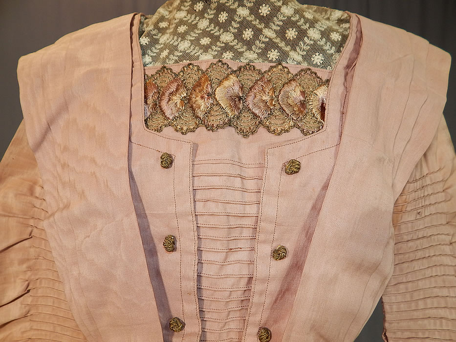 Edwardian Pleated Pink Cotton Silk Moire Gold Embroidered Lace Collar Dress Gown
This pretty pink dress has a layered embellished top, with high collar, long full pleated sleeves, a fitted waist, with separate sash belt, rosette metallic stamens on the back, a long full pleated skirt, hook closures down the back and the top is fully lined. 