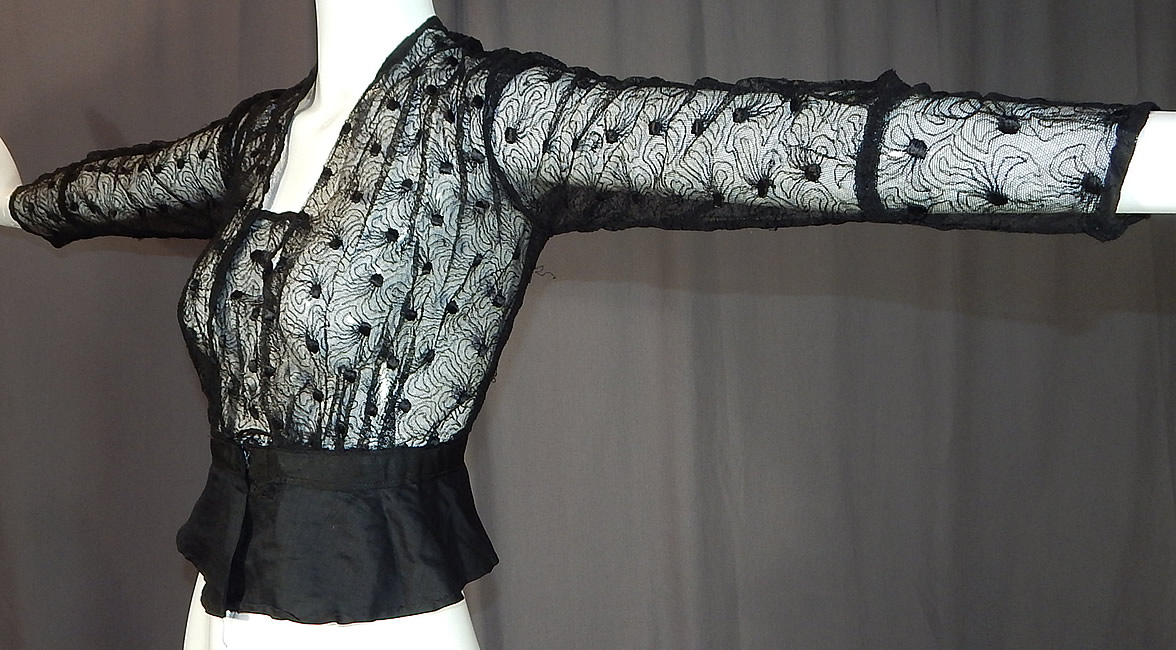 Edwardian Sheer Black Net Lace Embroidered Spiral Flower Blouse Shirt Top
This antique Edwardian era sheer black net lace embroidered spiral flower blouse shirt top dates from 1910. It is made of a sheer black net lace lace fabric, with an embroidered abstract spiraling flower pattern design.