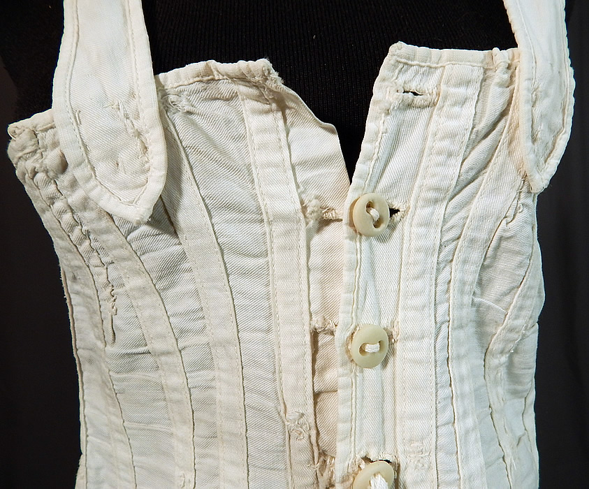 Victorian White Cotton Twill Stays Health Corset Camisole Top Underwear
This "Perfect Health" style stays corset has a camisole top with shoulder straps, button front closures and adjustable corseted lacing back. The corset measures 19 inches long, with a 28 inch waist and 30 inch bust. It is in fair as-is condition, with some wear, a few small mended repairs, replaced corset strings with pink silk ribbon and is missing the top button (see close-up). 