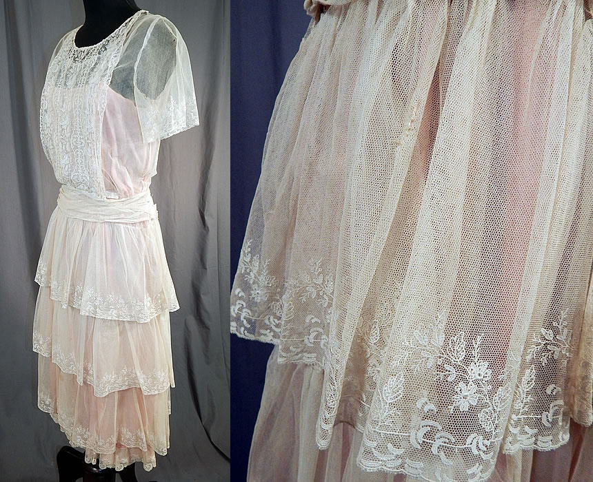 Vintage White Net Brussels Applique Duchesse Bobbin Lace Pink Silk Slip Dress
This lovely lace dress has a pink silk slip lining sewn inside, with a bib front top, short sleeves, a pleated gathered belted waistband, tiered ruffle layered full skirt, with snaps and hook closures along the side. 