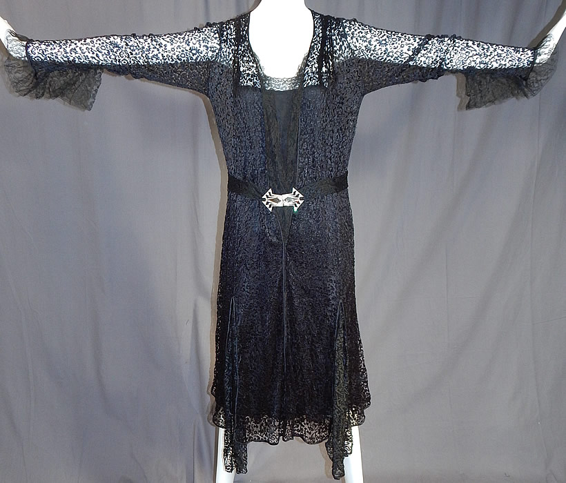 Vintage Art Deco Buckle Belted Black Silk & Chantilly Lace Flapper Dress
It is made of a sheer black silk fishnet lace fabric with a floral pattern and a fine black Chantilly lace trim edging down the top front opening and sleeve cuffs. 