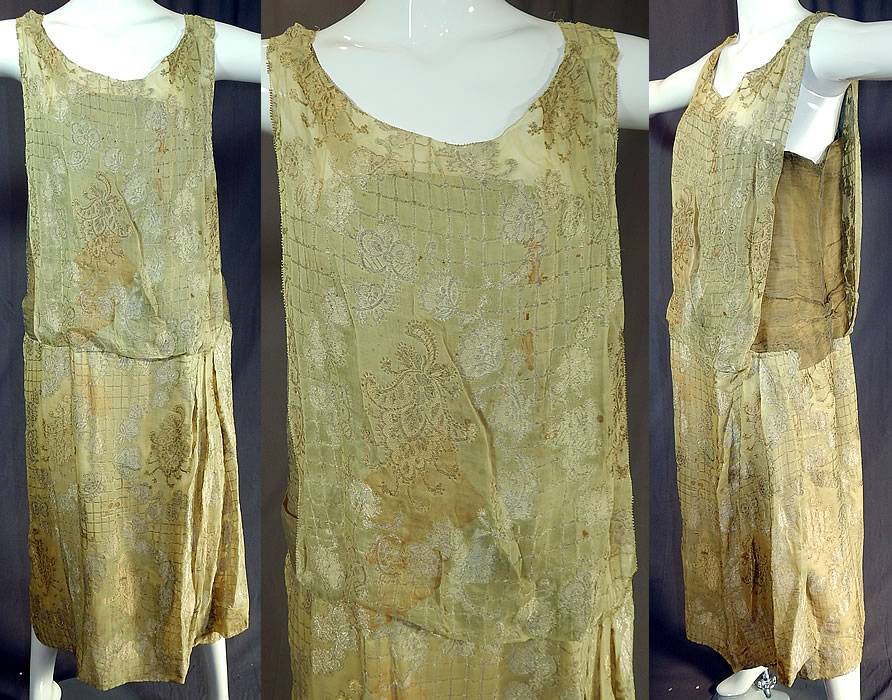 Vintage Art Deco Chartreuse Gold Lam&eacute; Lame Silk Damask Drop Waist Flapper Dress
This vintage Art Deco chartreuse gold lam&eacute; silk damask drop waist flapper dress dates from the 1920s. It is made of a chartreuse yellowish green color silk lam&eacute; fabric with a gold and silver metallic thread damask weave brocade pattern woven design. 