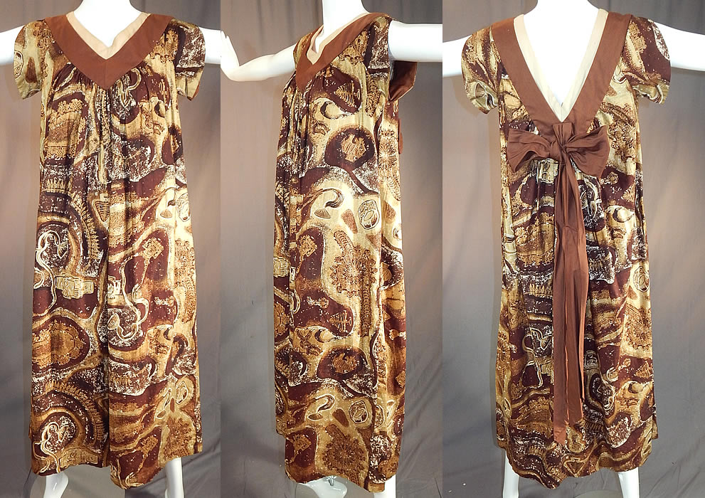 Vintage Watumulls Leilani Hawaii Indonesian Batik Print Gold Cotton MuuMuu Dress
This vintage Watumulls Leilani Hawaii Indonesian batik print gold cotton muumuu dress dates from the 1950s. It is made of varying shades of brown, yellow and gold metallic highlights Indonesian inspired batik print silk screen cotton fabric with elephants, trees, temples, pagoda shrines, masks and figural dancers. 