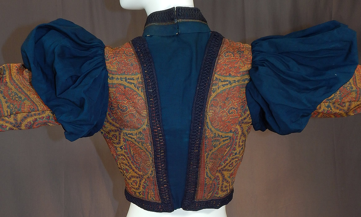 Victorian A.E. Parsons Boston Paisley Brocade Navy Blue Wool Gigot Mutton Sleeve Bodice
This beautiful bodice blouse shirt top, has a navy blue braided trim band collar, blue pleated front insert, long leg of mutton gigot style sleeves with a blue pouf top tapering down, a fitted waist with braided trim, hook closures down the front and is fully lined with quality construction detail, stays boning sewn inside.