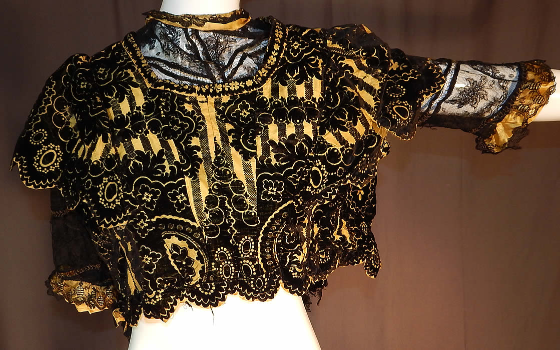 Victorian Yellow Silk Black Burnout Voided Velvet Devore Chantilly Lace Bodice
This antique Victorian era yellow silk black burnout voided velvet devore Chantilly lace bodice dates from 1880. 