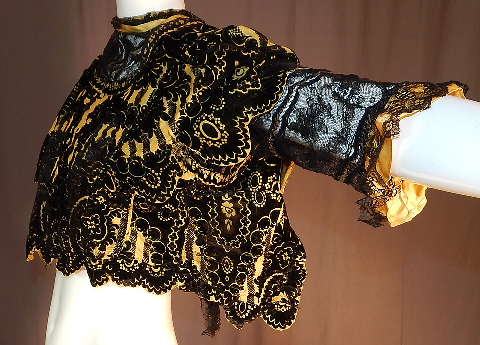 Victorian Yellow Silk Black Burnout Voided Velvet Devore Chantilly Lace Bodice
This beautiful bodice has a short cropped top blouse style, with a sheer black Chantilly lace lining underneath, short lace sleeves with gold metallic thread stitching, ruffle cuffs, a high lace trimmed neckline and a scalloped edging open back with no closure. 