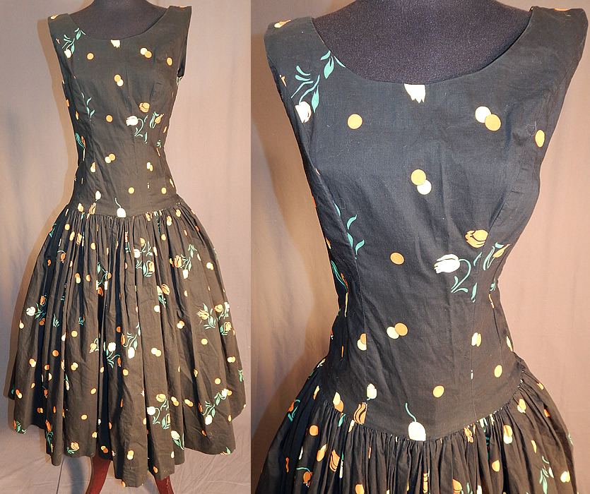 Vintage Black Cotton Polka Dot Tulip Novelty Print Fit & Flare Circle Skirt Dress
This vintage black cotton polka dot, tulip novelty print fit and flare cotton circle skirt dress dates from the 1950s. It is made of a black cotton fabric, with orange and white polka dots and tulip flowers novelty print design.