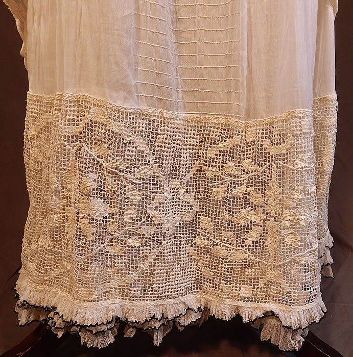 Edwardian Titanic Embroidered French Knot Batiste Filet Lace Lawn Dress Tea Gown
This lovely lace lawn dress tea gown is a long floor length with a layered tiered style , net lace trim yoke neckline, 3/4 length sleeves, weighted overskirts, black trimmed net ruffle pleated hemline, hook snap closures down the back (some missing) and is fully lined.