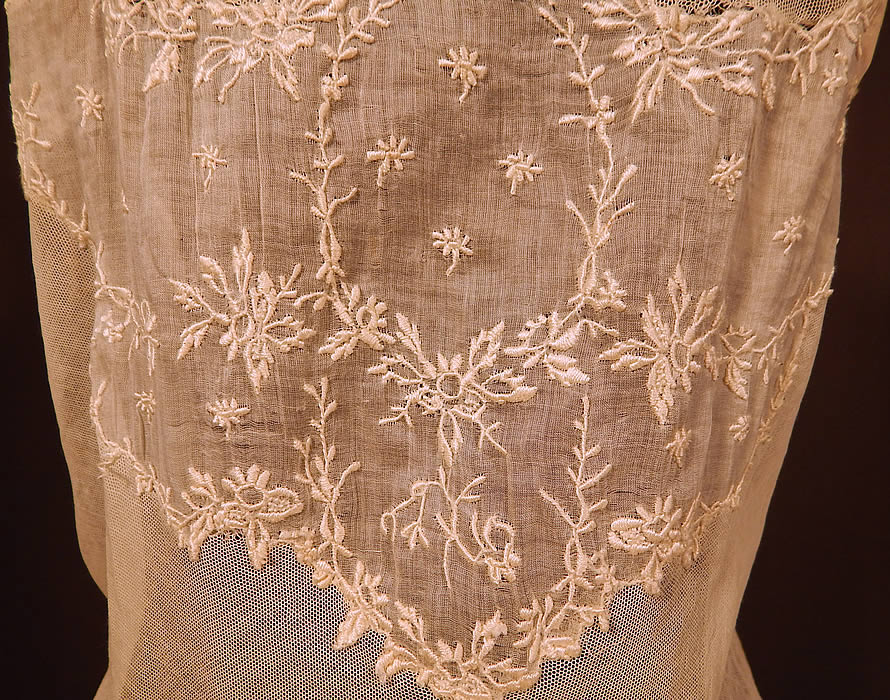 Victorian Cream Cotton Batiste Embroidery Applique Lace Lawn Dress Tea Gown
This lovely lace lawn dress tea gown is a long floor length with a high empire waist, draping sash belted back, lace trim yoke neckline, gathered shoulders with 3/4 length sleeves, hook closures down the back and is fully lined with petticoat slip skirt and stays boning inside the bodice waist area. 