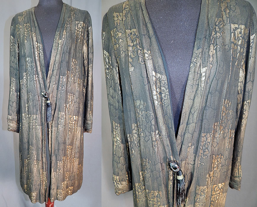 Vintage Art Deco Black Silk Gold Lam&eacute; Lame Long Flapper Coat Jacket Tassel Trim
This vintage Art Deco black silk gold lam&eacute; long flapper coat jacket tassel trim dates from the 1920s. It is made of a black and gold metallic lam&eacute; thread woven fabric in an abstract varying up and down steps resembling a city skyline and floral designs.