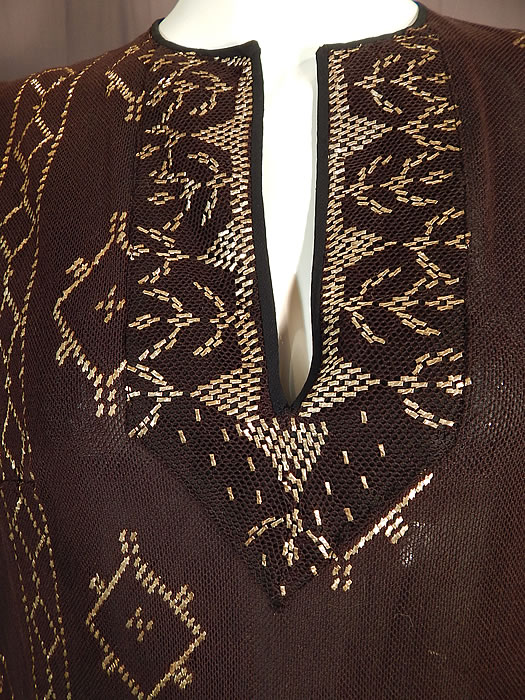 Vintage Art Deco Egyptian Assuit Shawl Black Net Silver Studded Kaftan Dress
This stunning Assuit shawl has been beautifully pieced together and made into a loose fitting kaftan style, long below knee length dress, with a V front studded neckline placket, long full sleeves and is fully lined in a black silk fabric inside. 