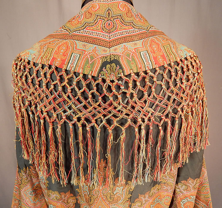 Victorian Antique Wool Paisley Shawl Collar Belted Robe Morning Dressing Gown
There is a wide shawl collar, with decorative hand knotted macram&eacute; fringe border trim, a black silk rope tassel tie ends sash belt, long full sleeves, a patch pocket, inside snap closures along the front and is fully lined in a gold polished cotton fabric. 