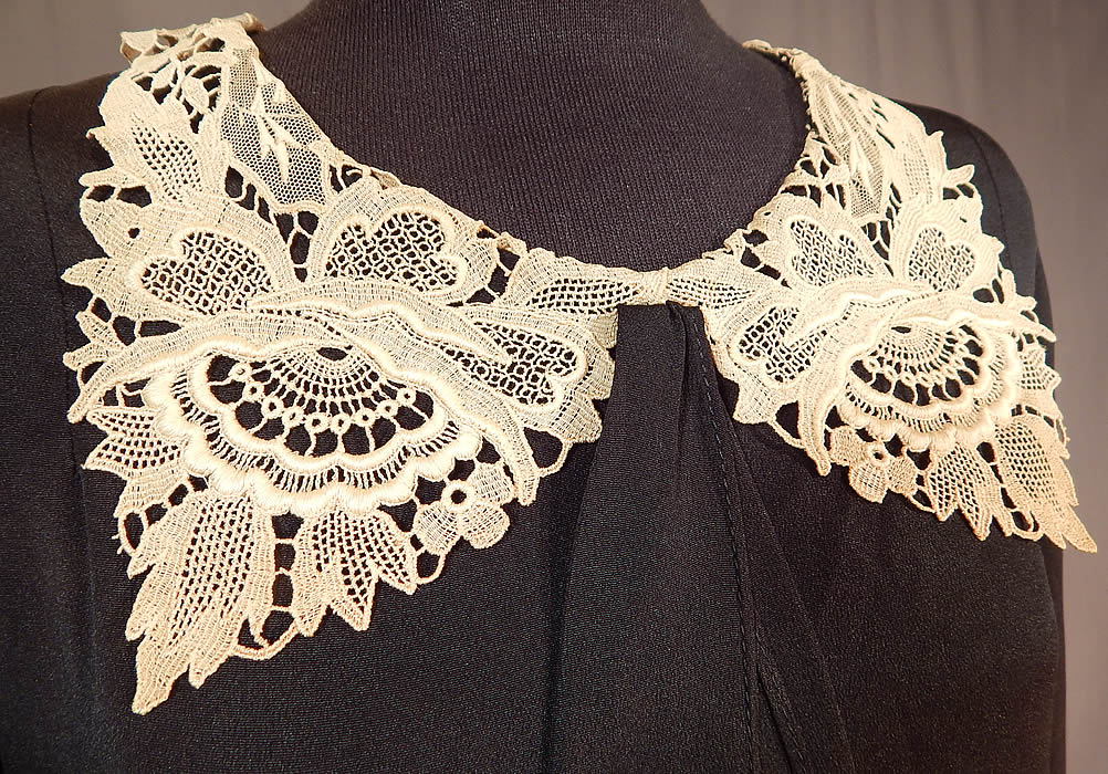 Vintage Black Silk Crepe de Chine Cream Lace Collar Bias Cut Dress
This beautiful black bias cut day dress is a shorter mid length, with a lace trimmed shawl collar, neck tie scarf, long sleeves, a draped cape back top with button trim accents, no side opening closures and is unlined.