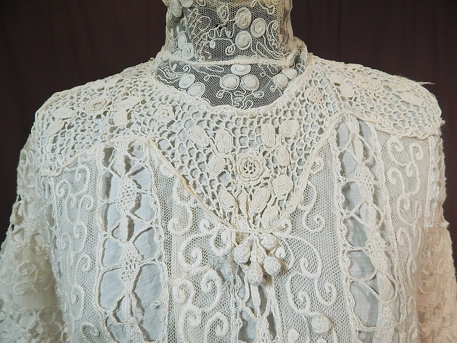 Edwardian Embroidered White Net Mixed Crochet Lace Bodice Blouse
This beautiful bodice blouse has a high neck lace collar with stays inside, 3/4 length sleeves, crochet lace ball fringe trim on the front, a fitted skirted peplum waist, snap closures down the back and is fully lined in a white cotton fabric. 