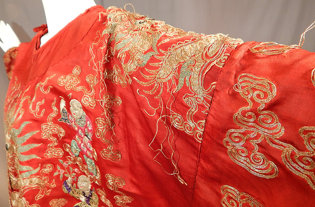Antique Chinese Dragon Phoenix Gold Couching Embroidery Red Silk Opera Robe
It is in good as-is condition, with some faint stains, wear along the neckline, 2 missing tie strap closures and some frayed loose gold thread couching work (see close-up). This is still a wonderful piece of antique Chinese textile art!