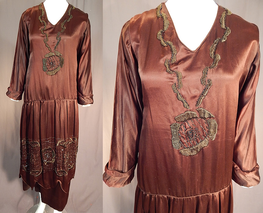 Vintage Art Deco Brown Silk Embroidered Bronze Beaded Flapper Dress Evening Gown
This vintage Art Deco brown silk embroidered bronze beaded flapper dress evening gown dates from 1920. It is made of a brown silk fabric, with brown raised padded satin stitch embroidery work, iridescent bronze beading done in Art Deco abstract floral design on the front top and bottom skirt.