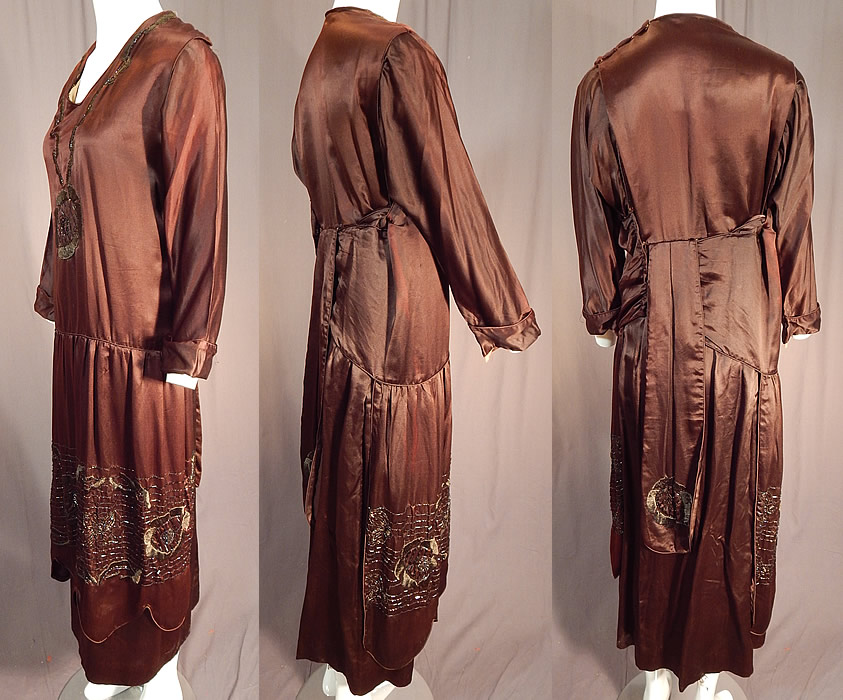 Vintage Art Deco Brown Silk Embroidered Bronze Beaded Flapper Dress Evening Gown
The dress measures 51 inches long, with a 36 inch bust, 34 inch waist and 21 inch long sleeves. 