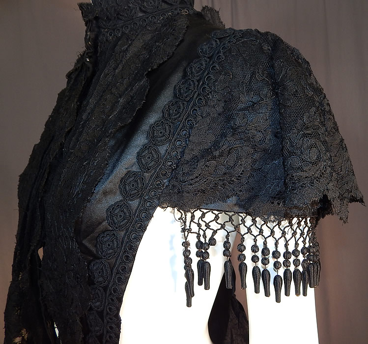 Victorian Black Silk Chantilly Lace Passementerie Mourning Mantle Pelerine Cape
It is in good as-is condition, with only a few missing silk ball fringe trim and some fraying on the inside silk lining. This is truly an amazing piece of antique Victoriana mourning wearable art!