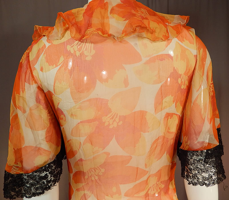 Vintage Floral Orange Blossom Print Silk Chiffon Black Lace Handkerchief Skirt Dress
This lovely luscious lace orange dress has a fitted waistband, short sleeves, a ruffle flounce collar neckline, backed in silk lining on the top only, an asymmetrical black lace handkerchief hemline skirt, no side opening closures and is sheer, unlined. 