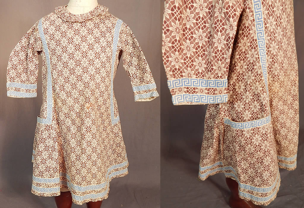 Victorian Childs Cotton Calico Brown Lace Pattern Print Greek Key Trim Dress
This antique Victorian era child's cotton calico brown lace pattern print Greek key trim dress dates from 1890. It is made of a brown and white cotton calico fabric, with a floral lace pattern print design and blue Greek key design ribbon trim edging.