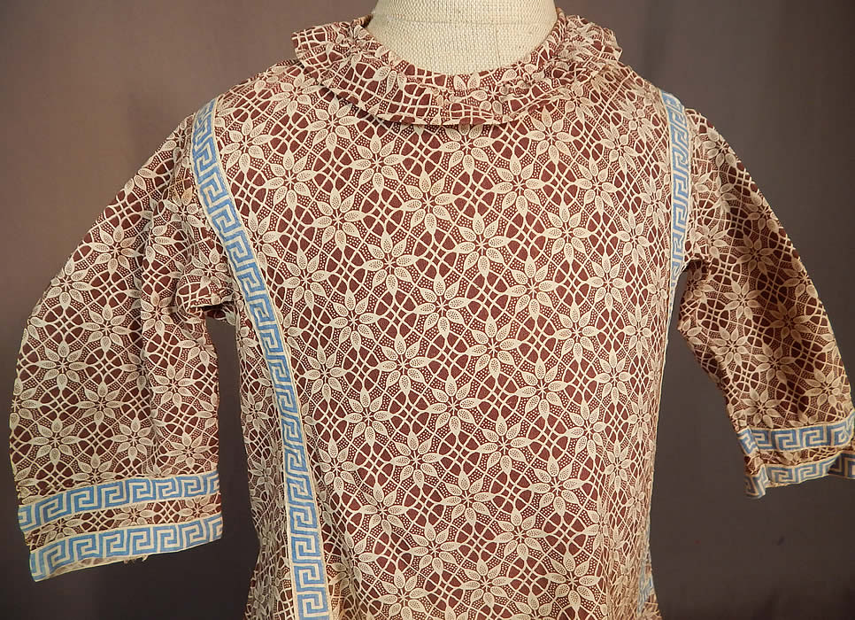 Victorian Childs Cotton Calico Brown Lace Pattern Print Greek Key Trim Dress
This charming child's dress has a loose fitting style, ruff collar, long sleeves, side skirt pocket, belted back, button back closures and is unlined. 